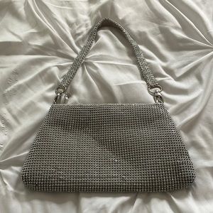 Sliver rhinestone purse with handle.
